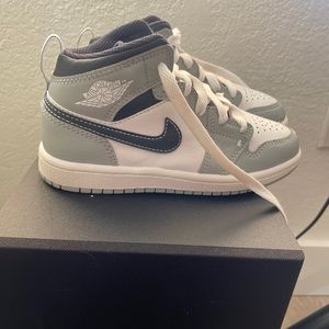 Size 12 boys (girls can wear too) grey, white, and black air Jordan mids.